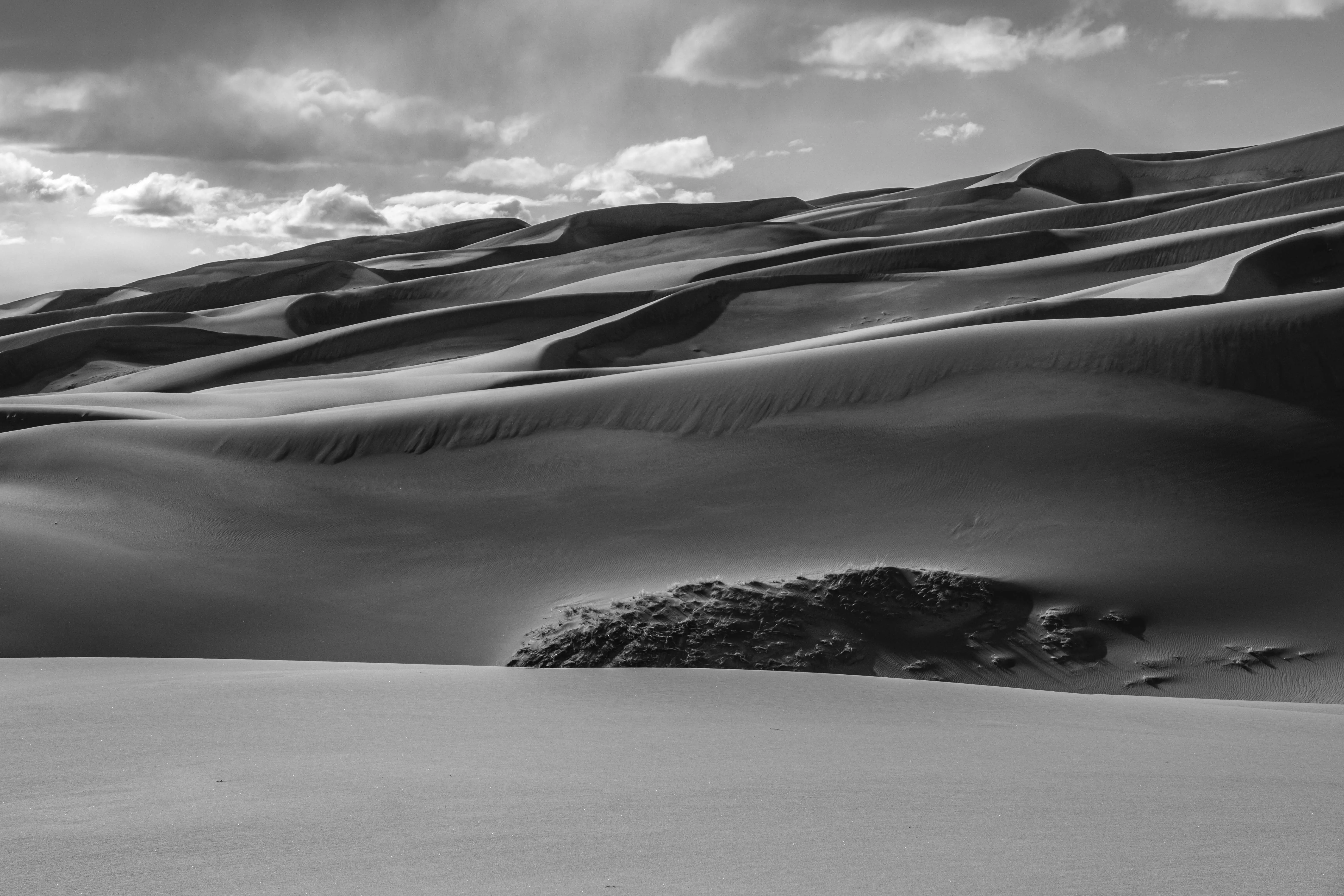 Dune hills with a cloudy sky.